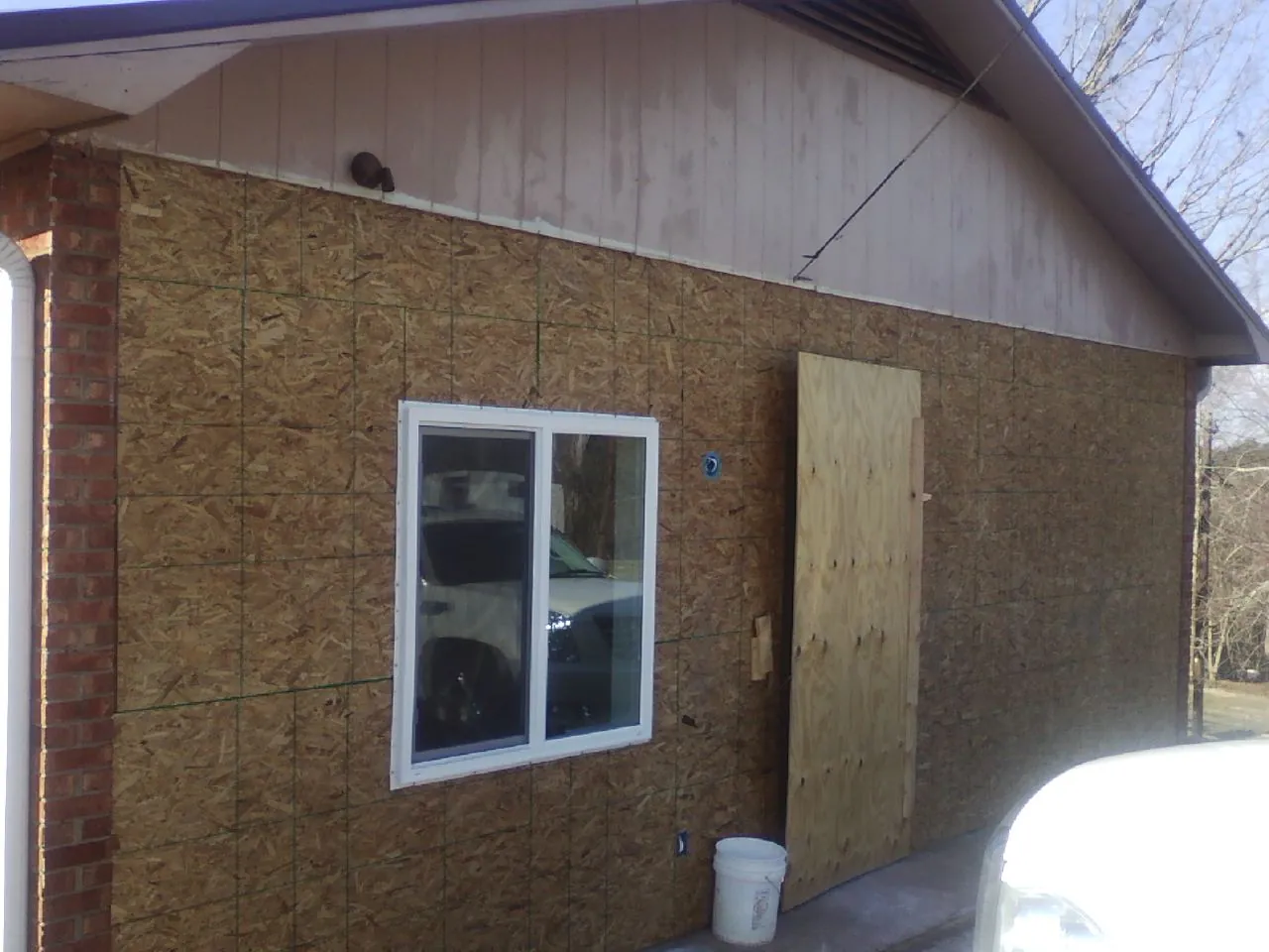 OSB sheathing on a garage addition wall before siding in Port Byron
