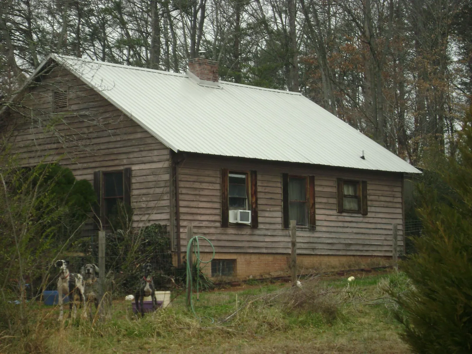 White metal roof on an old wood sided farmhouse, from a Metal Roof Installation job in Port Byron